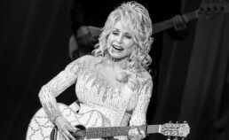 Dolly Parton in a bedazzled stage outfit, representing her independent intellectual property empire.